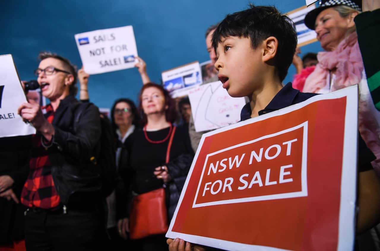 A child holds a placard during a protest against the decision to project the barrier draw results