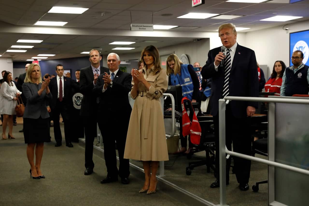 US President Donald J. Trump (R) with First Lady Melania Trump (C) and US Vice President Mike Pence (C-L) 