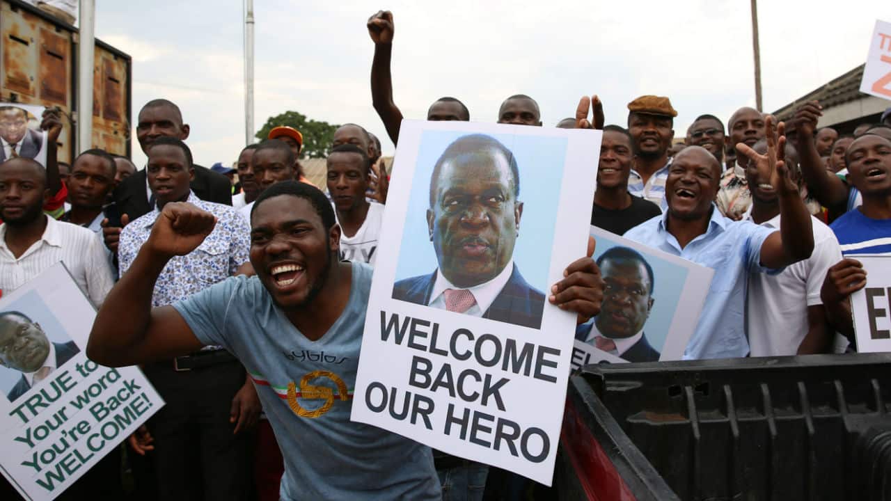 Crowds cheering for the return of Mr Mnangagwa to Zimbabwe.