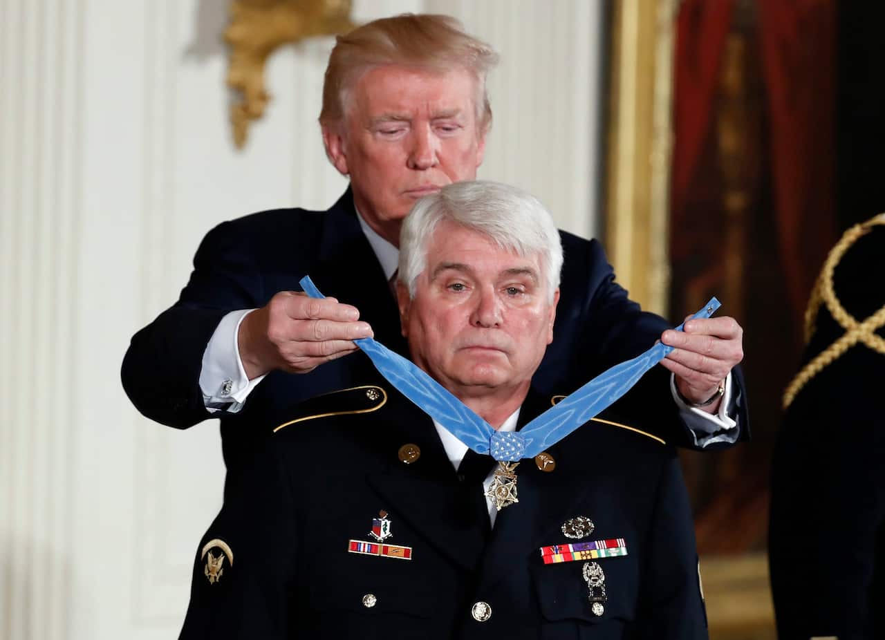 The original photos shows President Trump awarding the Medal of Honor to James C McCloughan at the White House in 2017.