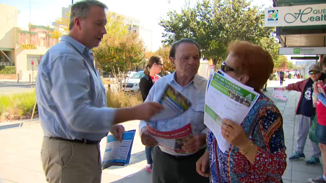 A Liberal Party volunteer gives out pro-Jim Molan material in Queanbeyan. 