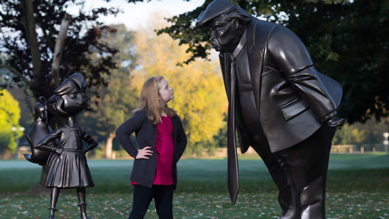 Mollie Sutton, eight, from Romford takes a look at a statue of Roald Dahl's Matilda which was unveiled in Great Missenden in Buckinghamshire.