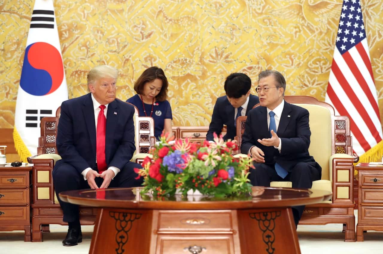 South Korean President Moon Jae-in (R) and US President Donald Trump speak during their talks at the presidential office Cheong Wa Dae in Seoul
