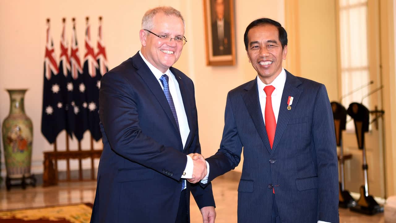 Australian Prime Minister Scott Morrison shakes hand with Indonesian President Joko Widodo during a meeting at the presidential palace in Bogor.