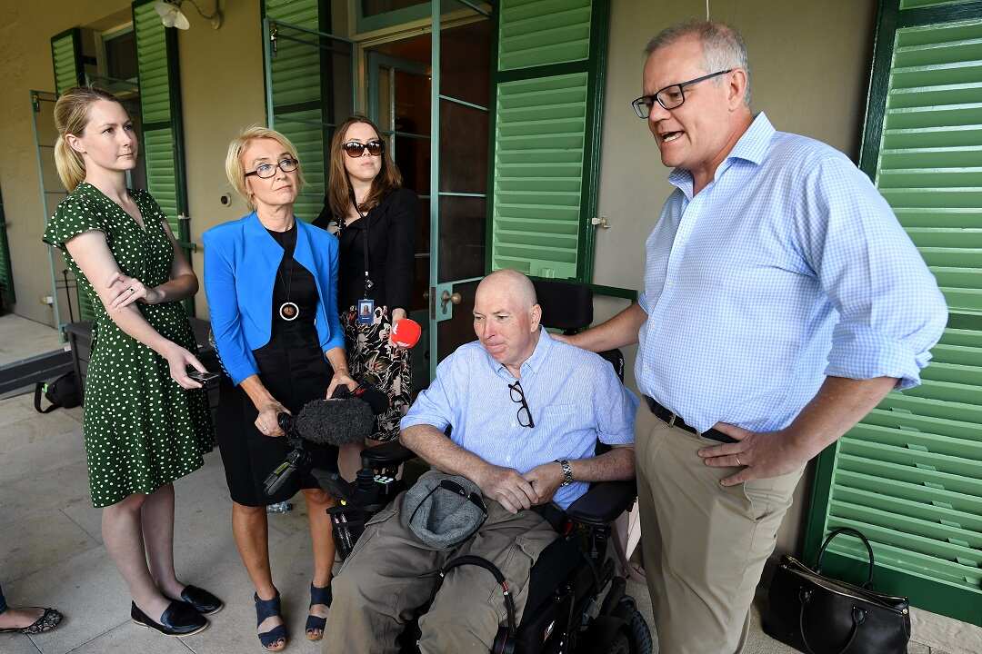 Prime Minister Scott Morrison (right) and brother-in-law Gary Warren (centre), who is a Multiple Sclerosis (MS) sufferer, speak to them media in Sydney, Sunday, December 23, 2018. (AAP Image/Joel Carrett) NO ARCHIVING