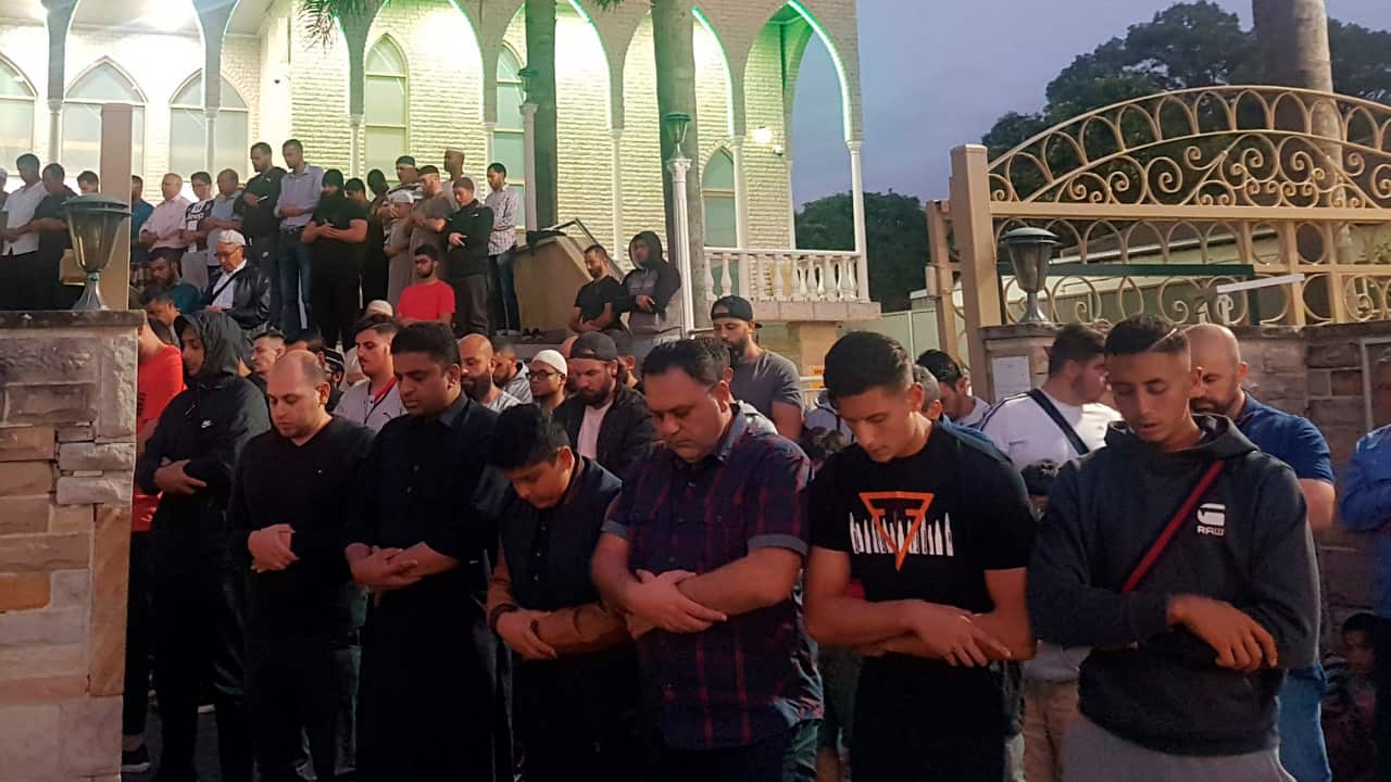 Worshipers pray for victims and families of the Christchurch shootings during an evening vigil a the Lakemba Mosque.