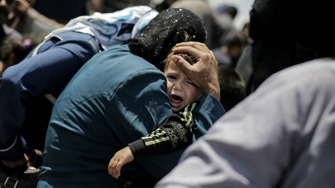 A child cries onboard a ferry to cross the Tigris River, as Mosul residents returned from the west to the liberated eastern part of the city.