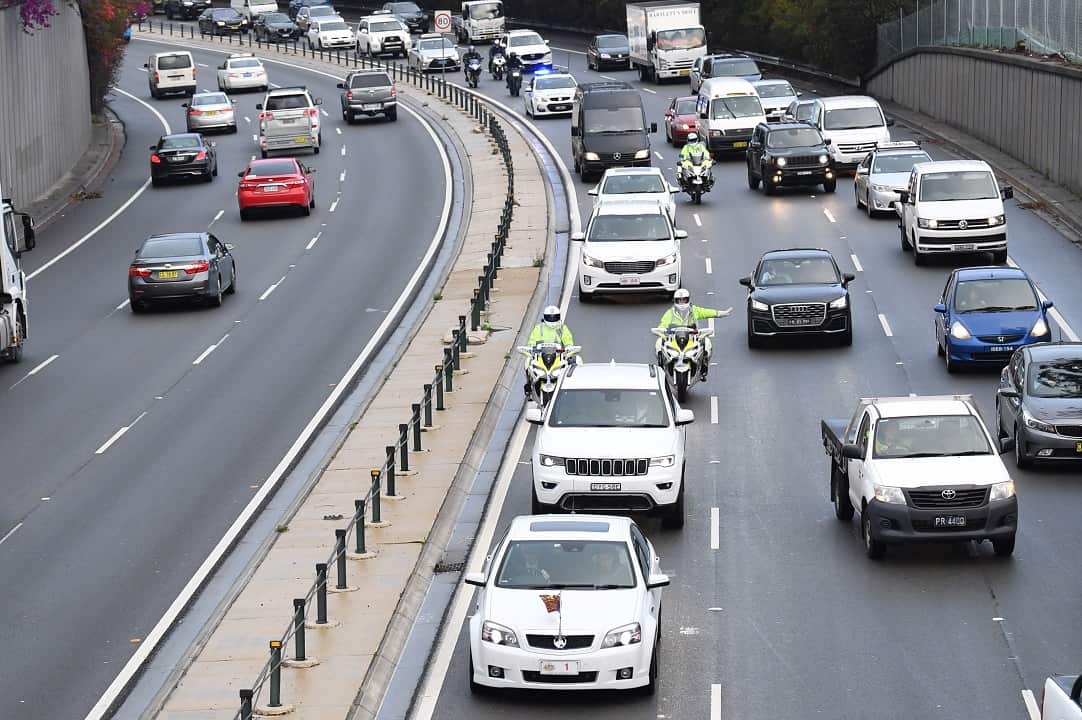 The motorcade makes its way through peak hour traffic on the Eastern Distributor in Sydney.