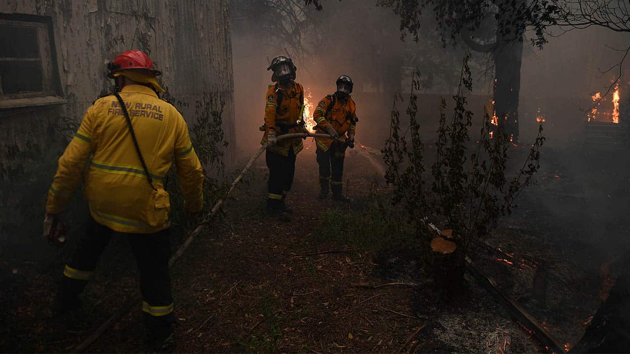 NSW Rural Fire Service crews fight the Gospers Mountain Fire as it impacts property at Bilpin.