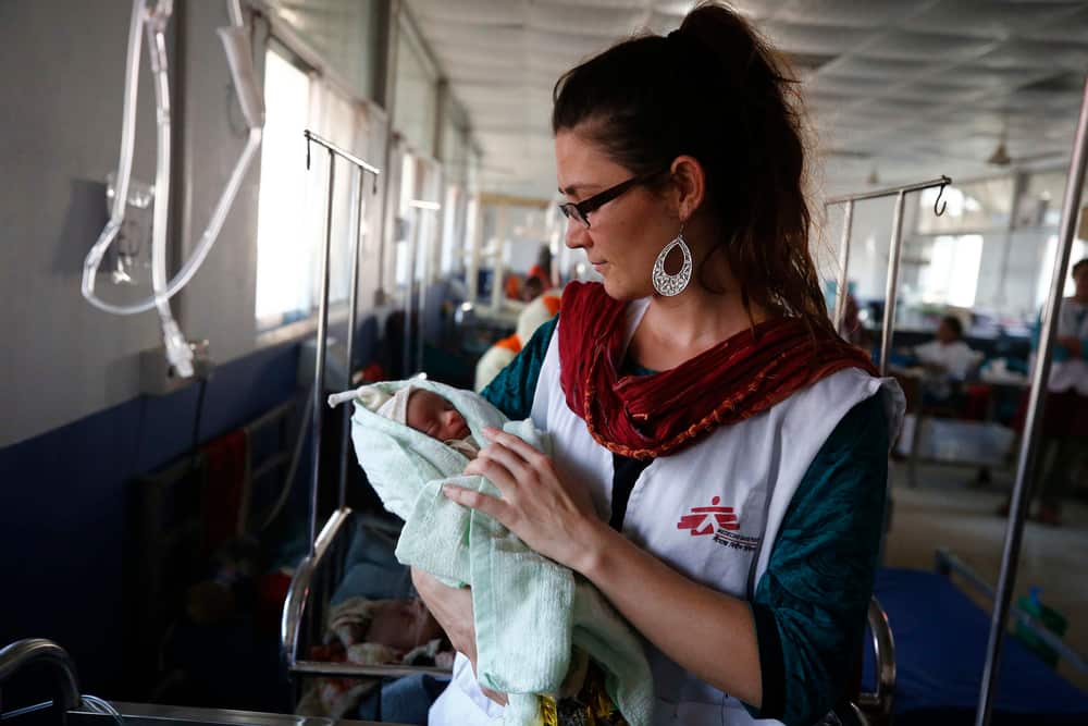 Sophie, an MSF nurse, with a little baby in Kutupalong MSF Hospital.