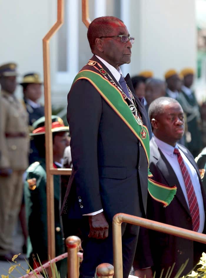 Zimbabwe President Robert Mugabe, stands as the national anthem is being played  before officially opening for the Parliament in Harare, Zimbabwe, Tuesday, Sept. 15, 2015. (AP/Photo Str)