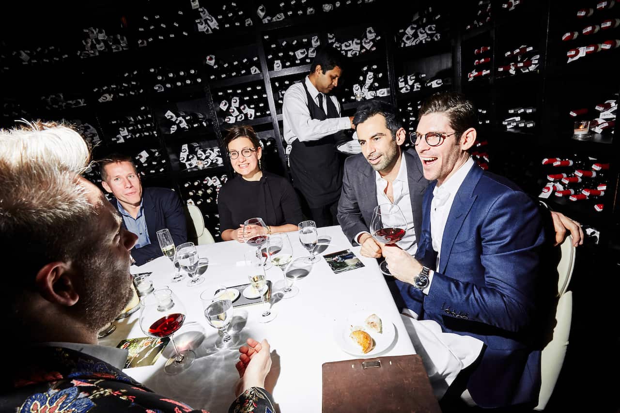 Brian Schaefer, far right, and his husband, Stephen Mack, with guests at a restaurant in New York.