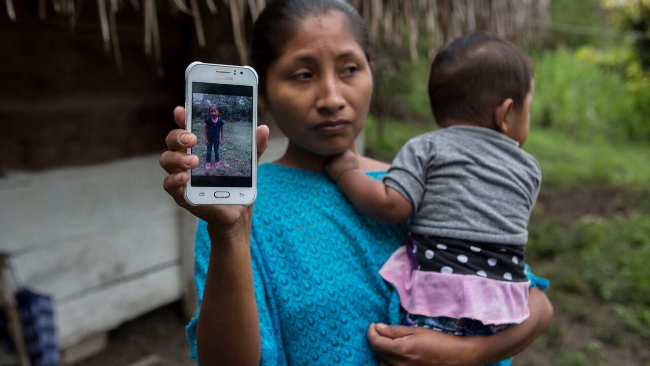 Claudia Maquin shows a photo of her daughter, Jakelin Amei Rosmery Caal Maquin in Raxruha, Guatemala.