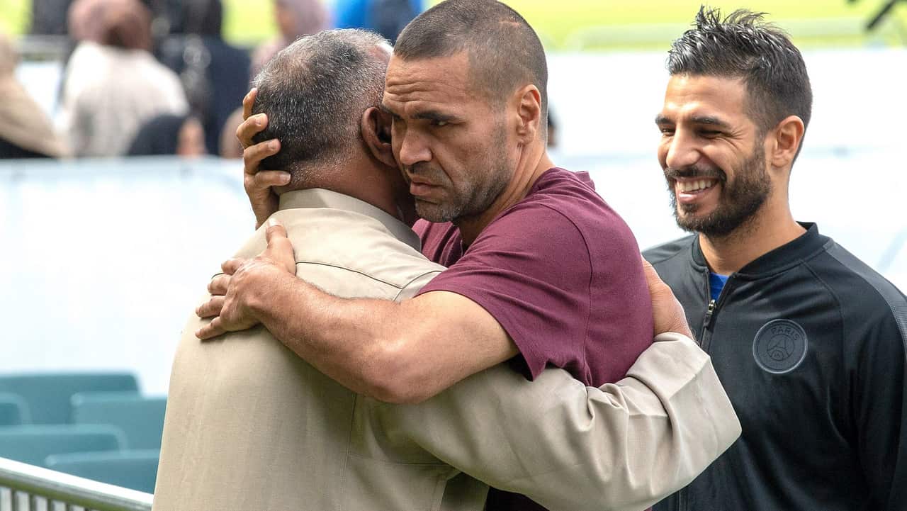 Australian boxer Anthony Mundine, centre, joins Muslims for the call to pray at Hagley Park, opposite the Al Noor Mosque.