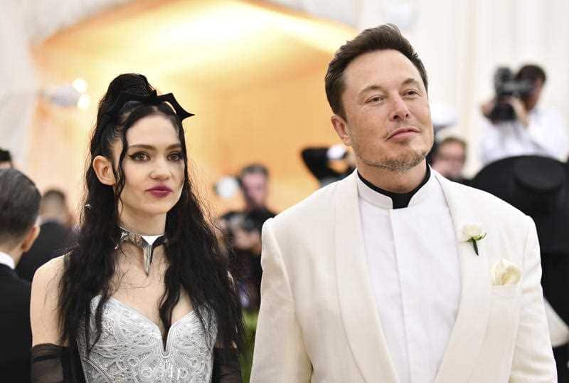 Under terms of the settlement, Musk, pictured with Grimes, is not permitted to be re-elected to the chairman post for three years.