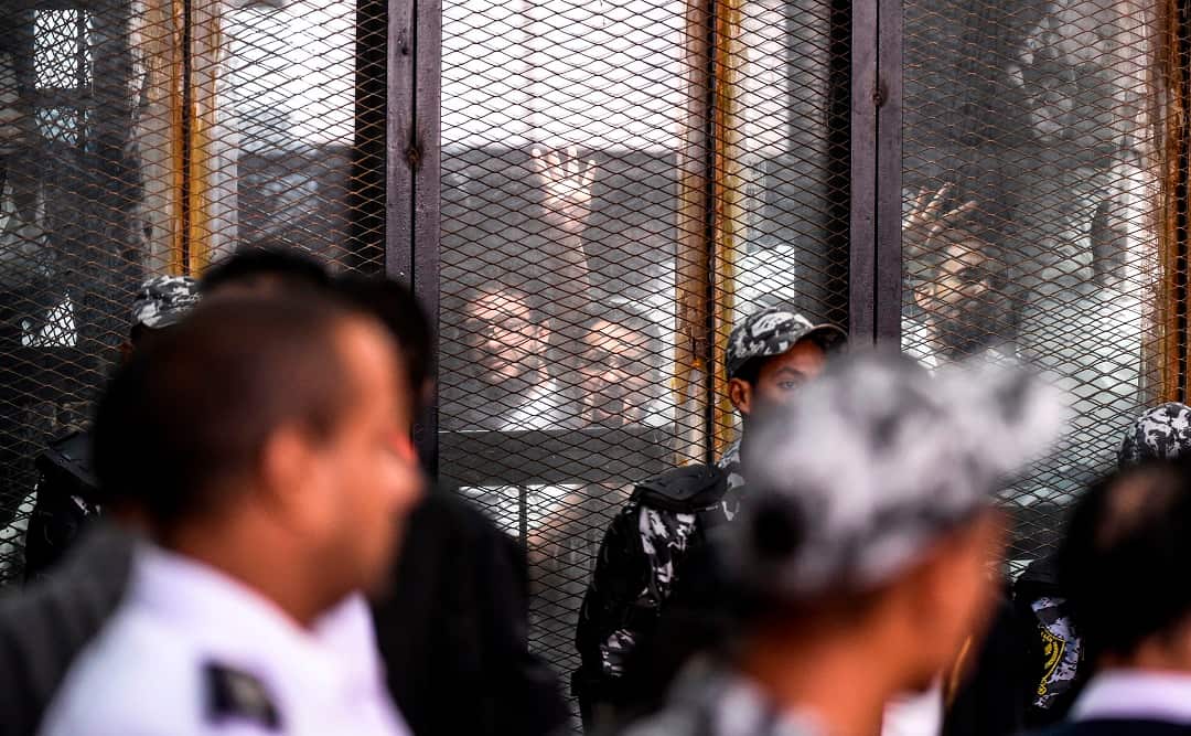 Members of Egypt's banned Muslim Brotherhood during their trial in July. 