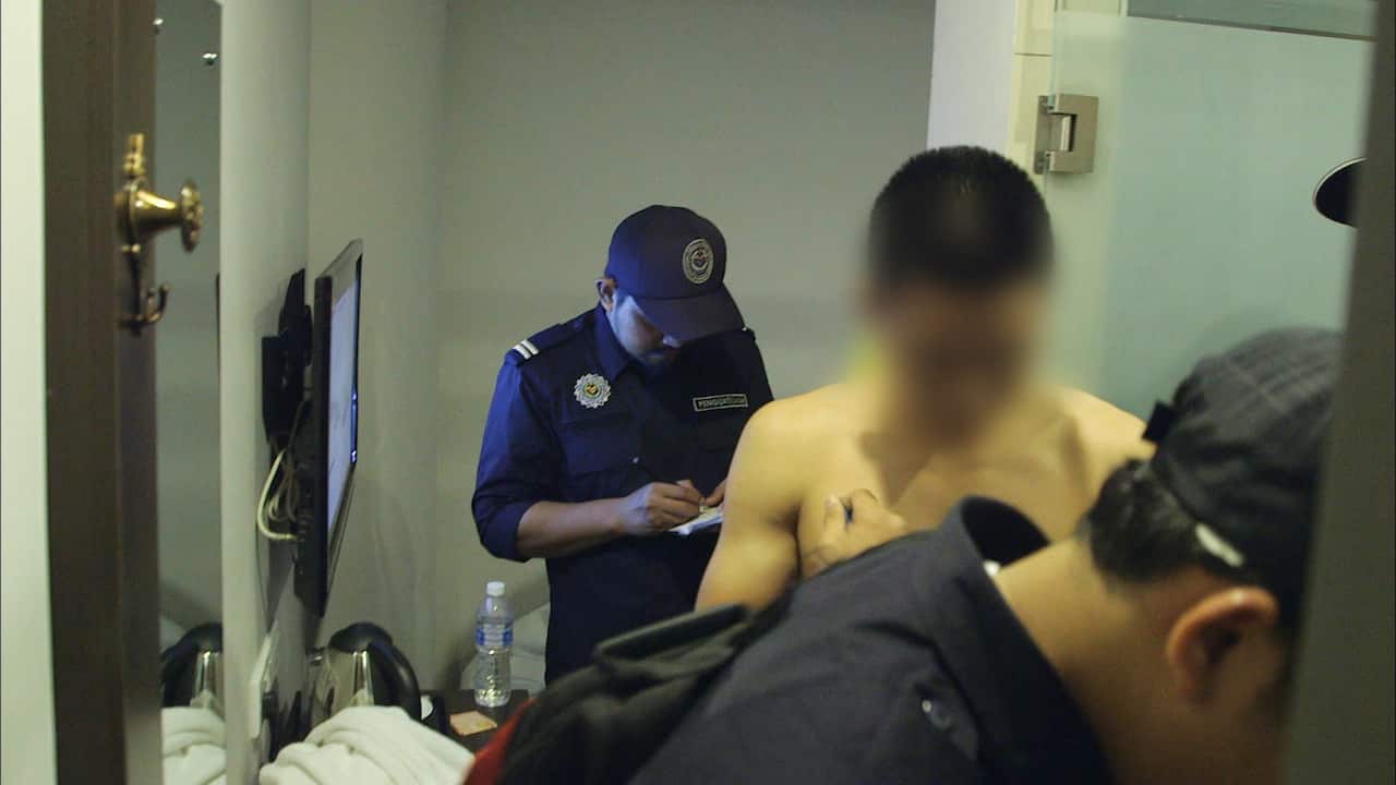 A young, unmarried couple are arrested by Malaysia's religious police for being in a hotel room together.