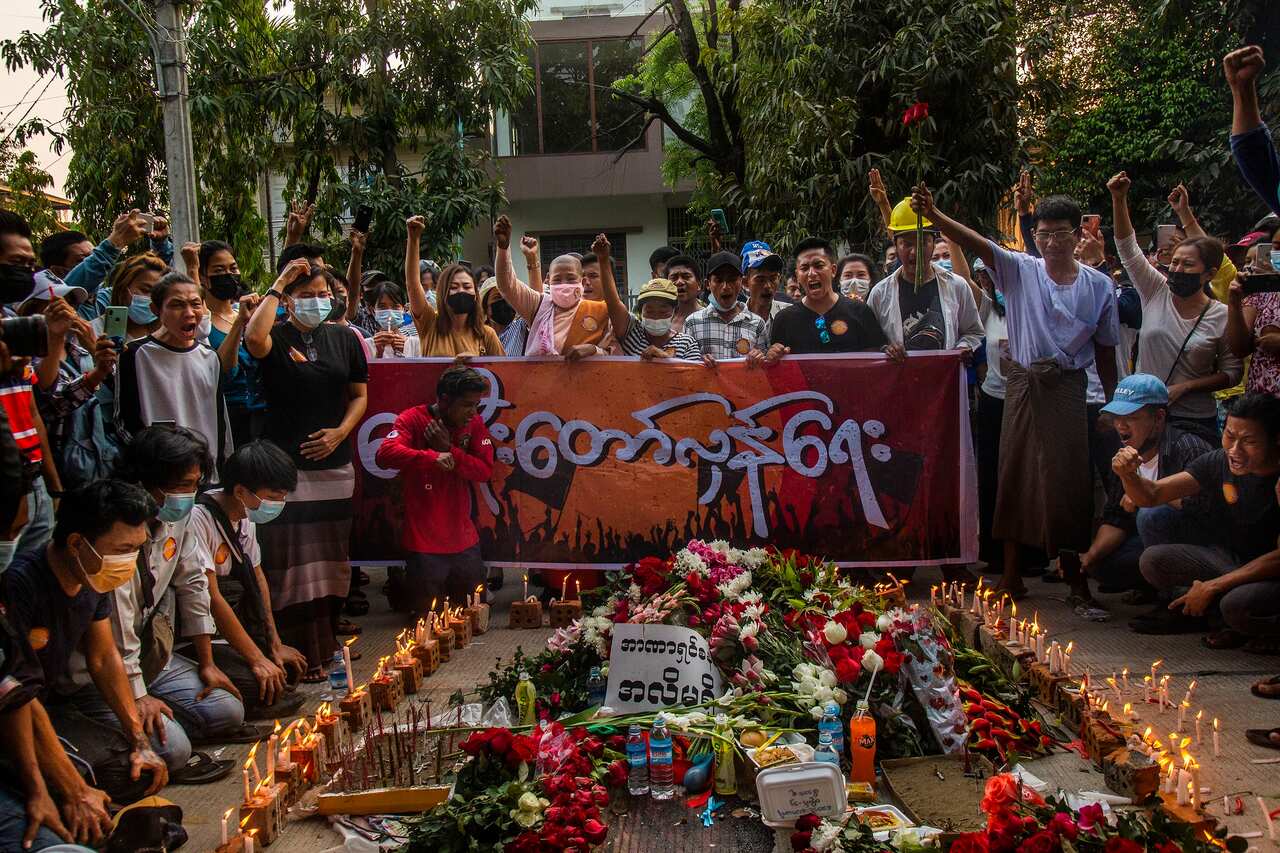 People shout slogans and light candles to honor Chit Min Thu, where he was shot during an anti-coup protest in North Dagon Town, Yangon, Myanmar.