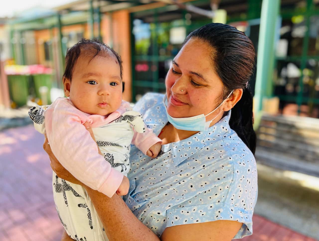 Narayani Siwakoti holding 3 month old Ronica