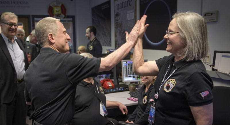 New Horizons principal investigator Alan Stern gives a high five too New Horizons Mission Operation Alice Bowman.