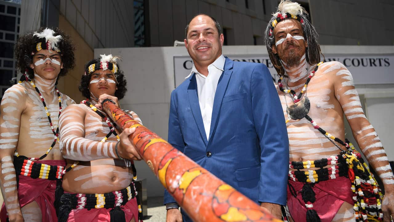 Quandamooka Yoolooburrabee Aboriginal Corporation CEO Cameron Costello (2nd right) and Aboriginal dancers pictured outside the Federal Court in Brisbane.