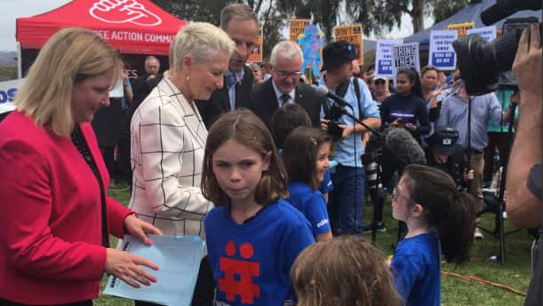 Kerryn Phelps receives the petition with 170,000 signatures.