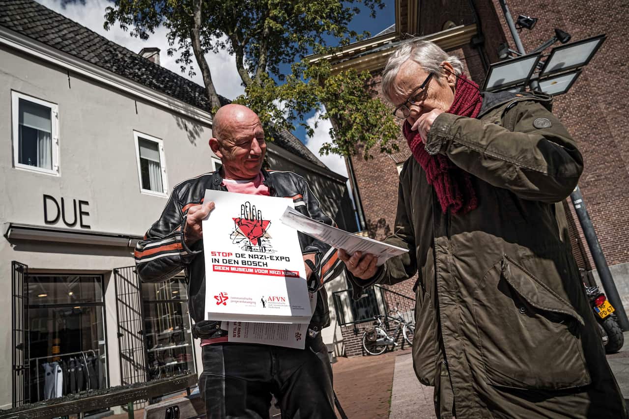 Protesters demonstrate outside the museum as the Design of the Third Reich exhibition opens on Sunday.
