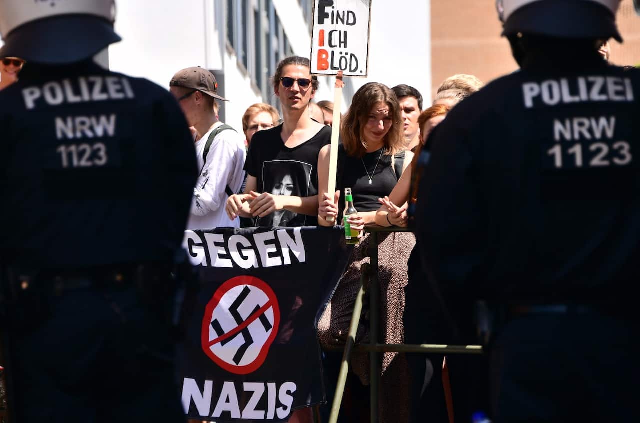 Counter-protesters hold up a banner reading 'I find it stupid' against a demonstration of the Identitarian Movement (Identitaere Bewegung) in Halle, Germany