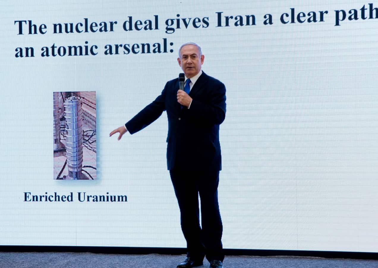 Israeli Prime Minister Benjamin Netanyahu presents material on Iranian nuclear weapons development during a press conference in Tel Aviv