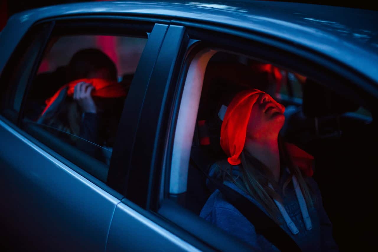 Children sit blindfolded in a car before participating in a Dutch tradition known as "dropping," where groups of children are deposited in a forest and have to find their way back to base, near Eindhoven, Netherlands, July 12, 2019. To make it more diffic