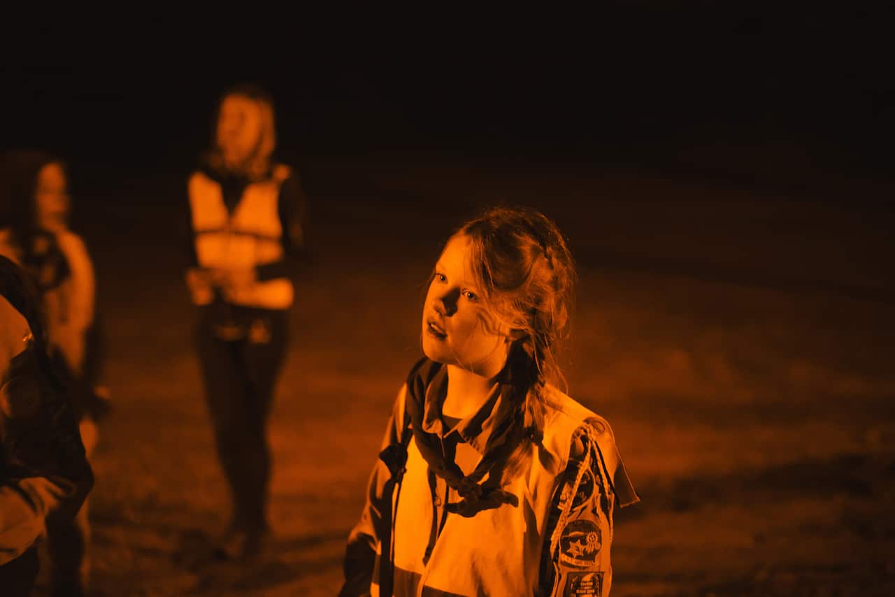 Demi de Winter, a scout, participates in a Dutch tradition known as "dropping," where groups of children are deposited in a forest and have to find their way back to base, near Utrecht, Netherlands. (Dmitry Kostyukov/The New York Times)