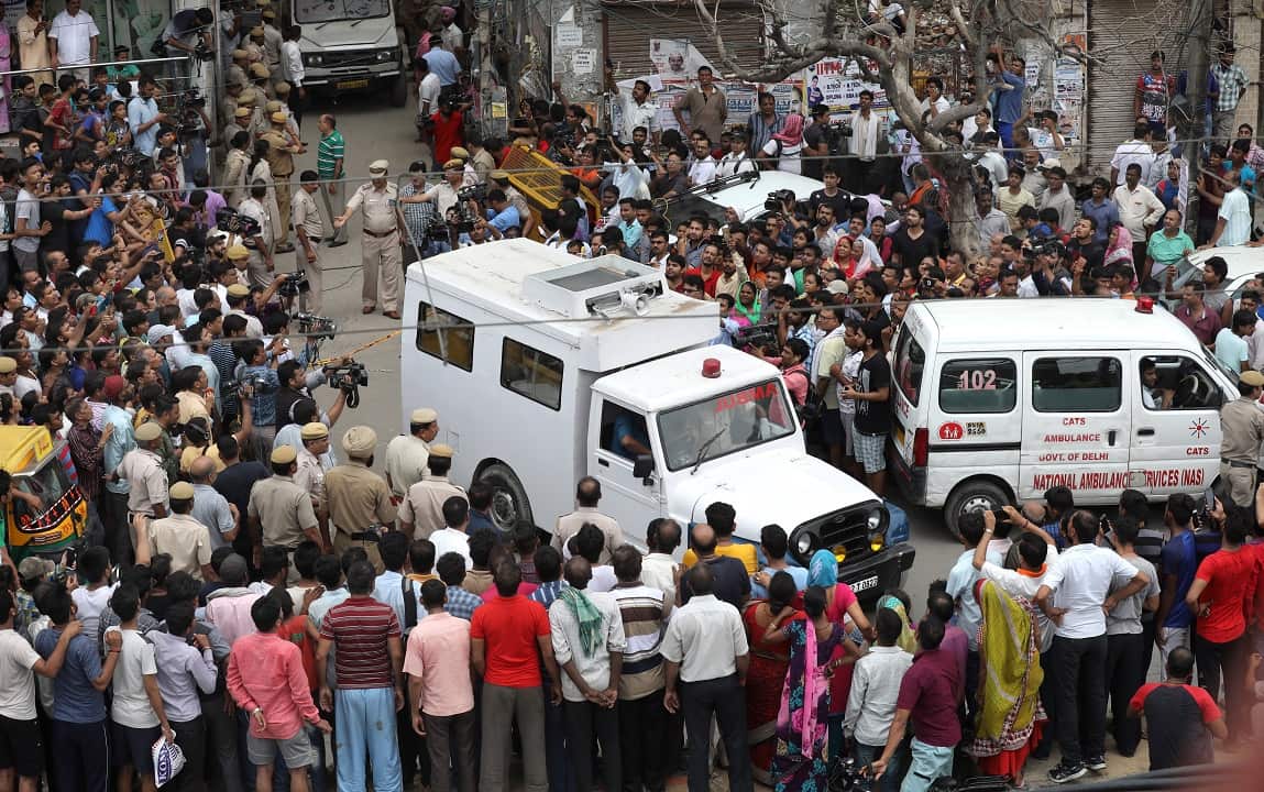 An ambulance leaves the scene.