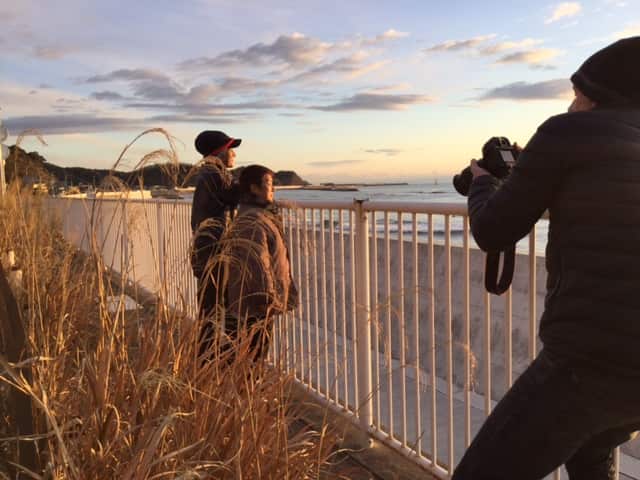 Dateline reporter Amos Roberts films couple Shikego and Takemasa Watanabe, as they watch the sun rise.