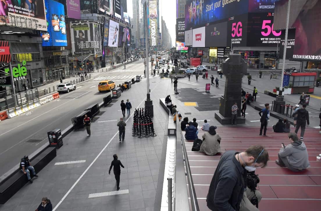 Almost no vehicle traffic and few pedestrians are seen in this Times Square photo, Thursday, March 20, 2020 in New York.