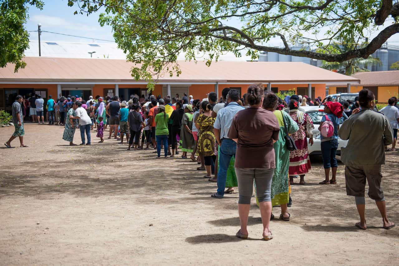 Residents of New Caledonia's capital, Noumea, wait in line at a polling station.