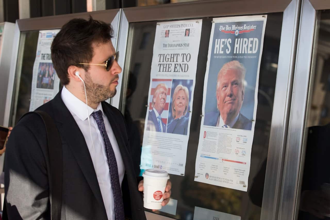 A man looks at election coverage on the front pages of today's newspapers on display outside the Newseum in Washington, DC, USA, 09 November 2016. 