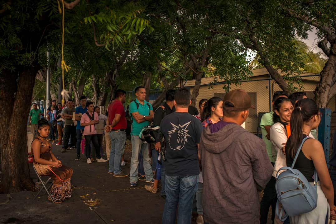 During the early morning, Nicaraguans wait in line to request a passport outside a government building in Managua, Nicaragua.