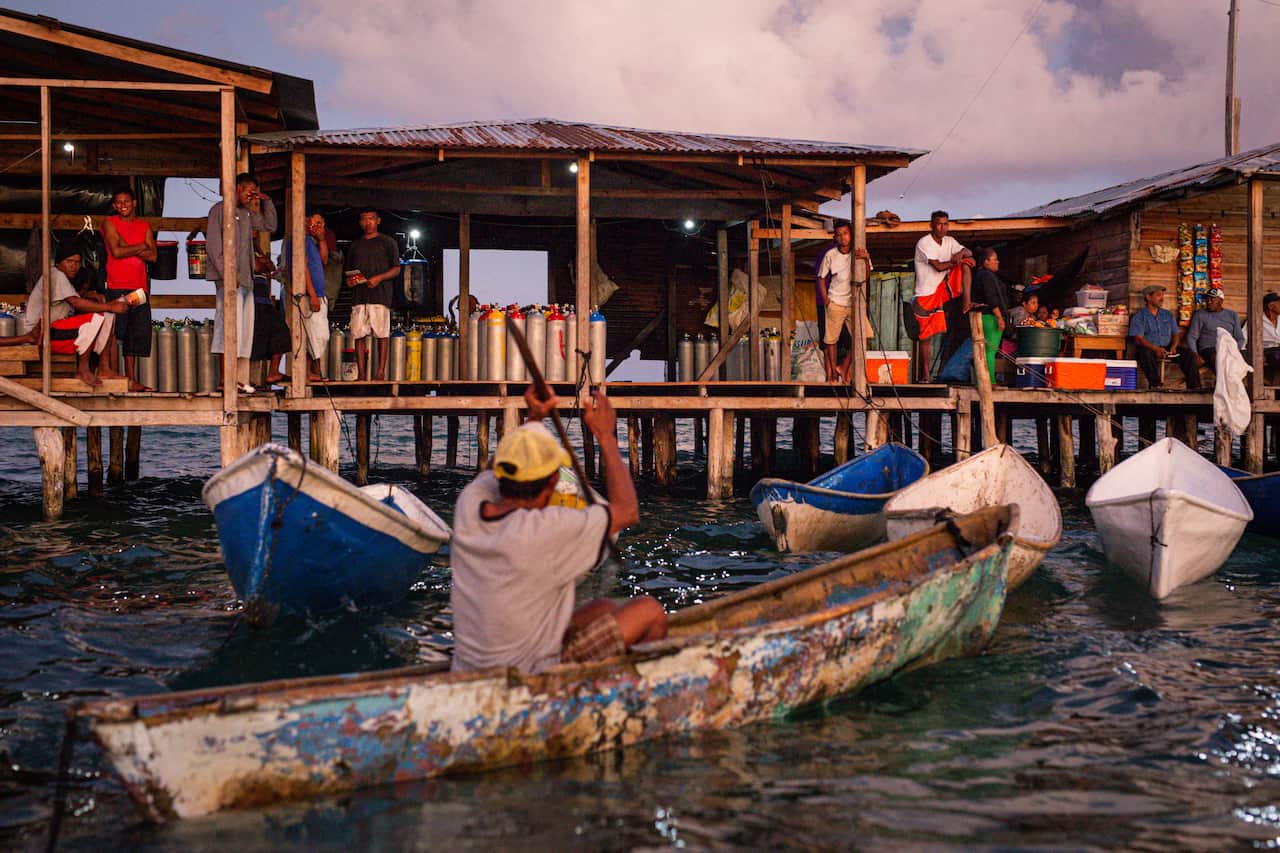 Divers gather in Diamond Cay, a village about 60 miles off the coast of Nicaragua, Feb. 1, 2021.     