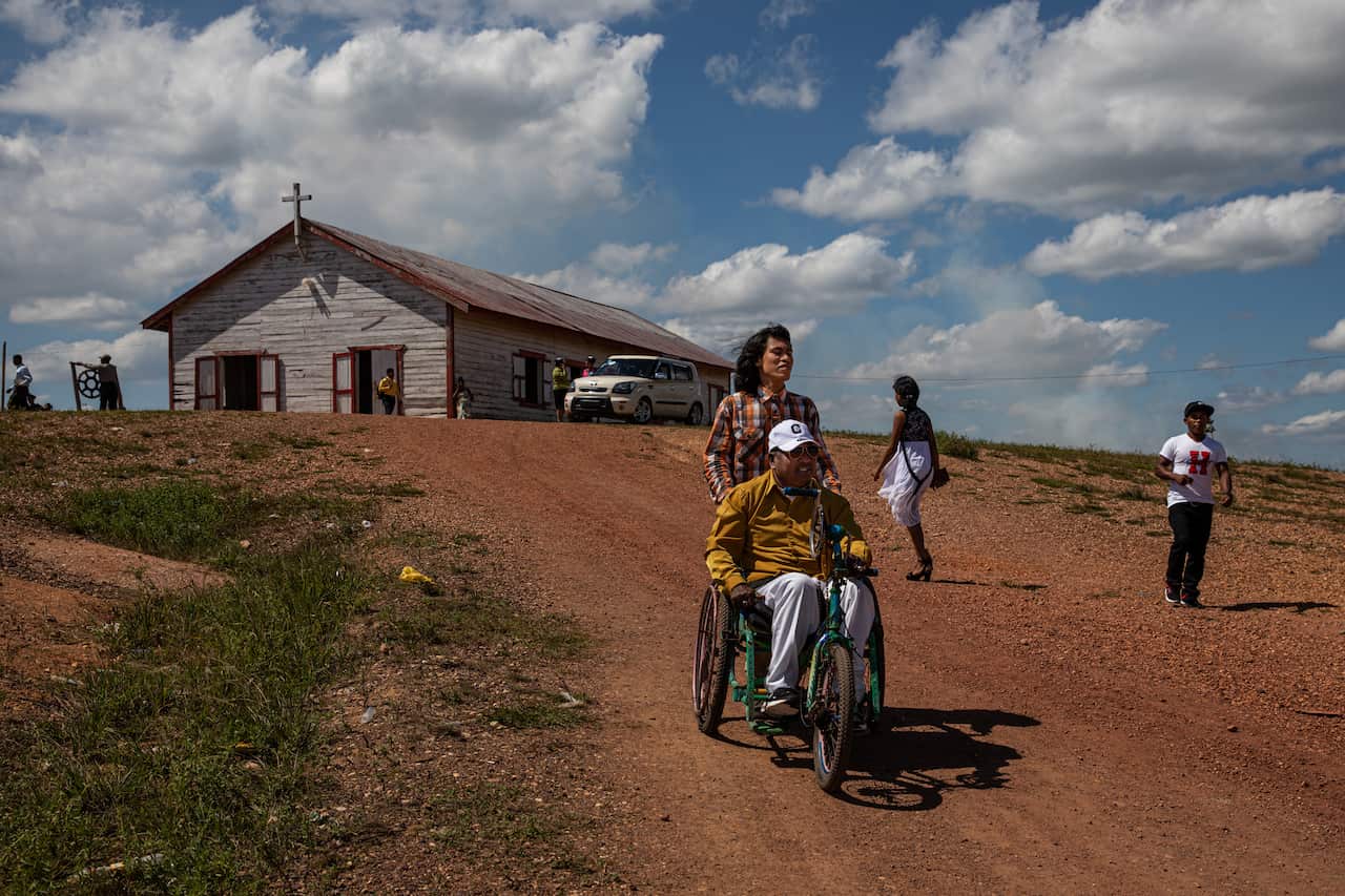 Oscar Flores pushes his father Felicito Flores after attending church in Puerto Cabezas, 2020. 