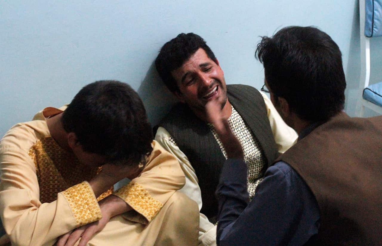 Relatives mourn after a suicide attack on a mosque in Heart, Afghanistan, Tuesday, Aug. 1, 2017 (AAP)