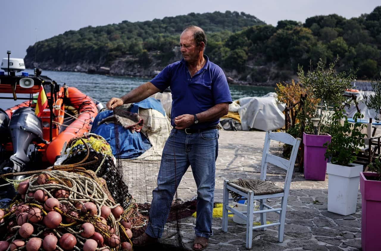 Greek fisherman Thanassis Marmarinos, 63, a Nobel Peace Prize nominee, repairs his fishing nets in the Skala Sikamias village on Lesbos (Getty)