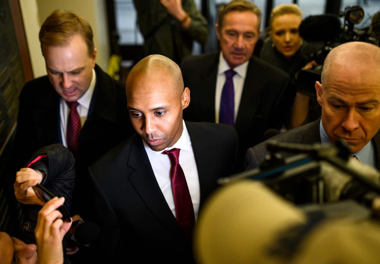 Former Minneapolis Police officer Mohamed Noor (C) arrives with his lawyers for the beginning of his trial on 1 April, 2019 in Minneapolis, Minnesota. 
