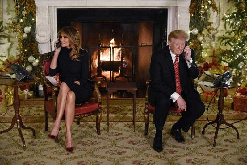 US President Donald Trump and the First Lady Melania Trump participate in NORAD Santa Tracker phone calls in the East Room of the White House.