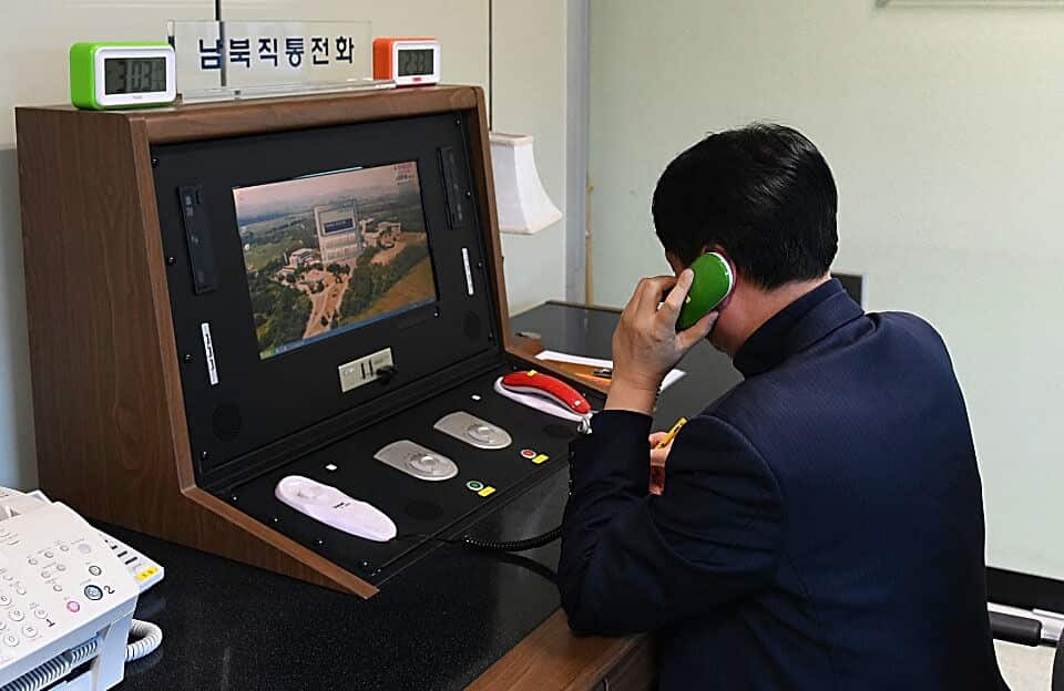 In this handout image, a South Korean government official checks the direct communications hotline to talk with North Korea.