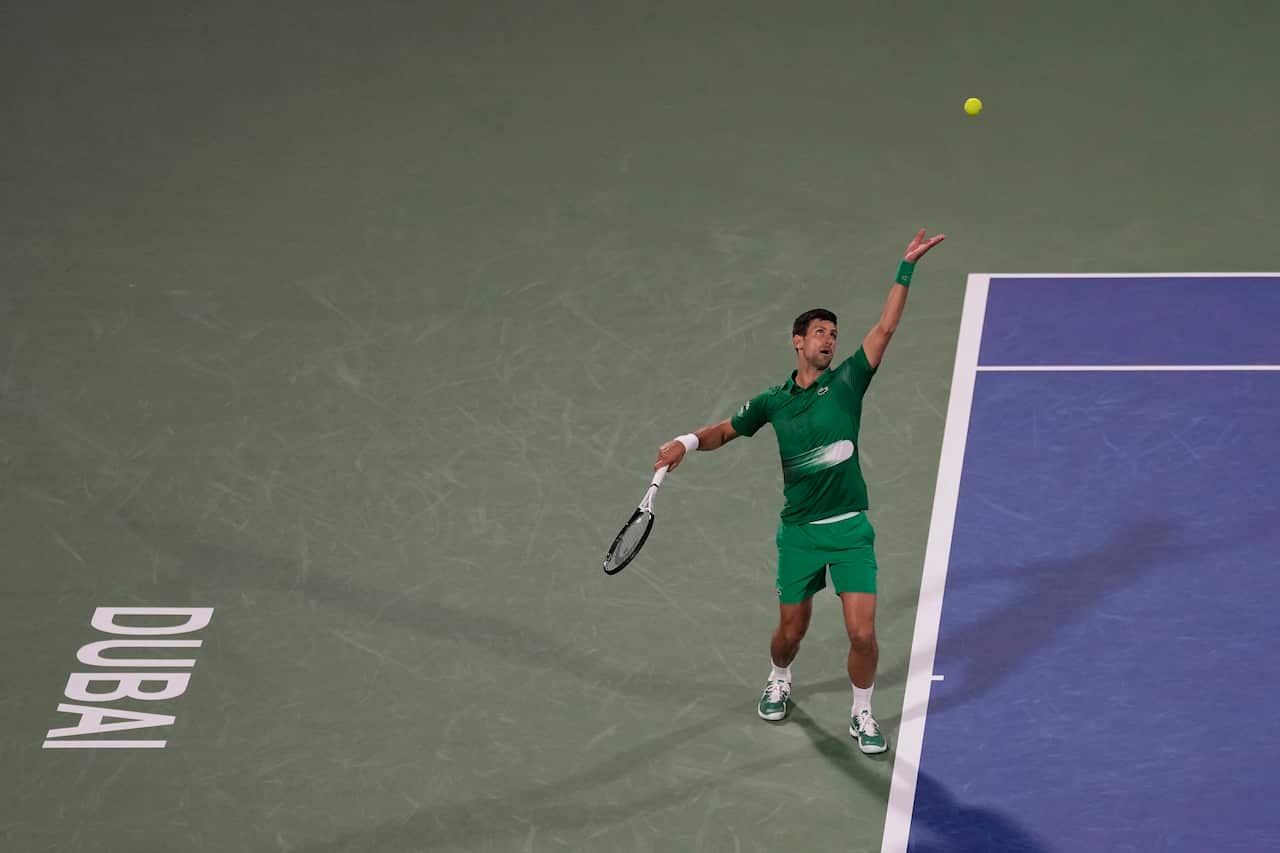 Novak Djokovic serves to Lorenzo Musetti during the Dubai Duty Free Tennis Championship.