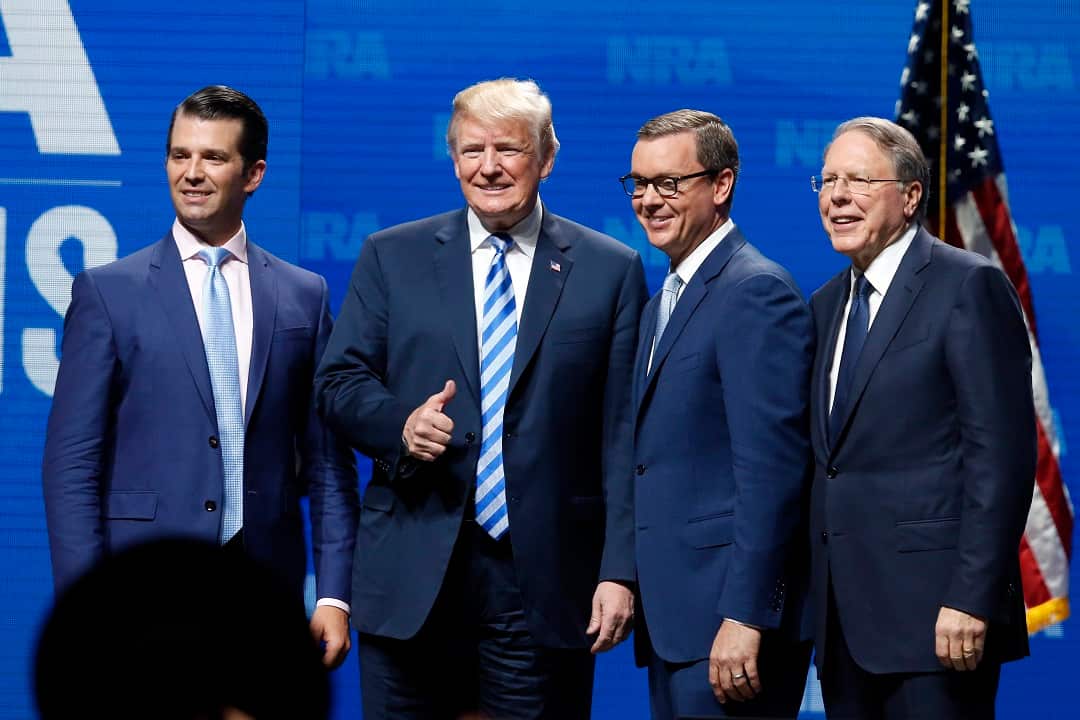 Donald Trump Jr. (left) and Donald Trump pose with Chris Cox and Wayne LaPierre from the NRA, right, at the NRA meeting in Dallas on Friday.