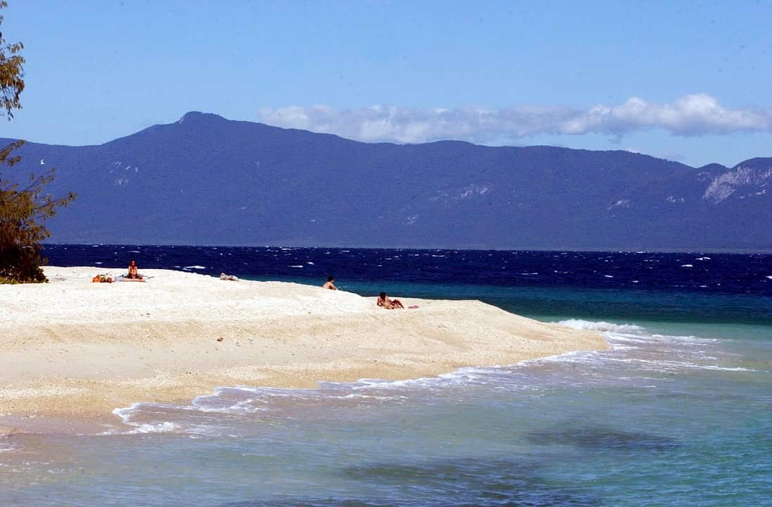 Tourists enjoy the tropical waters of Nudey Beach on Fitzroy Island.