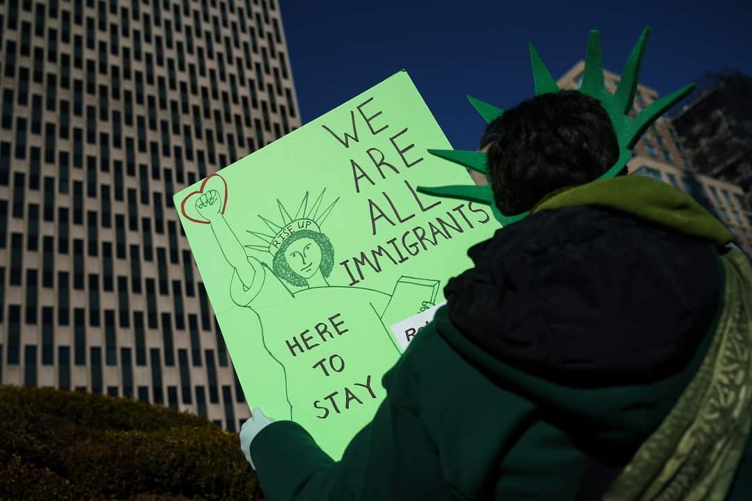 Immigration activists and clergy members participate in a silent prayer walk in protest against the Trump administration's immigration policies .