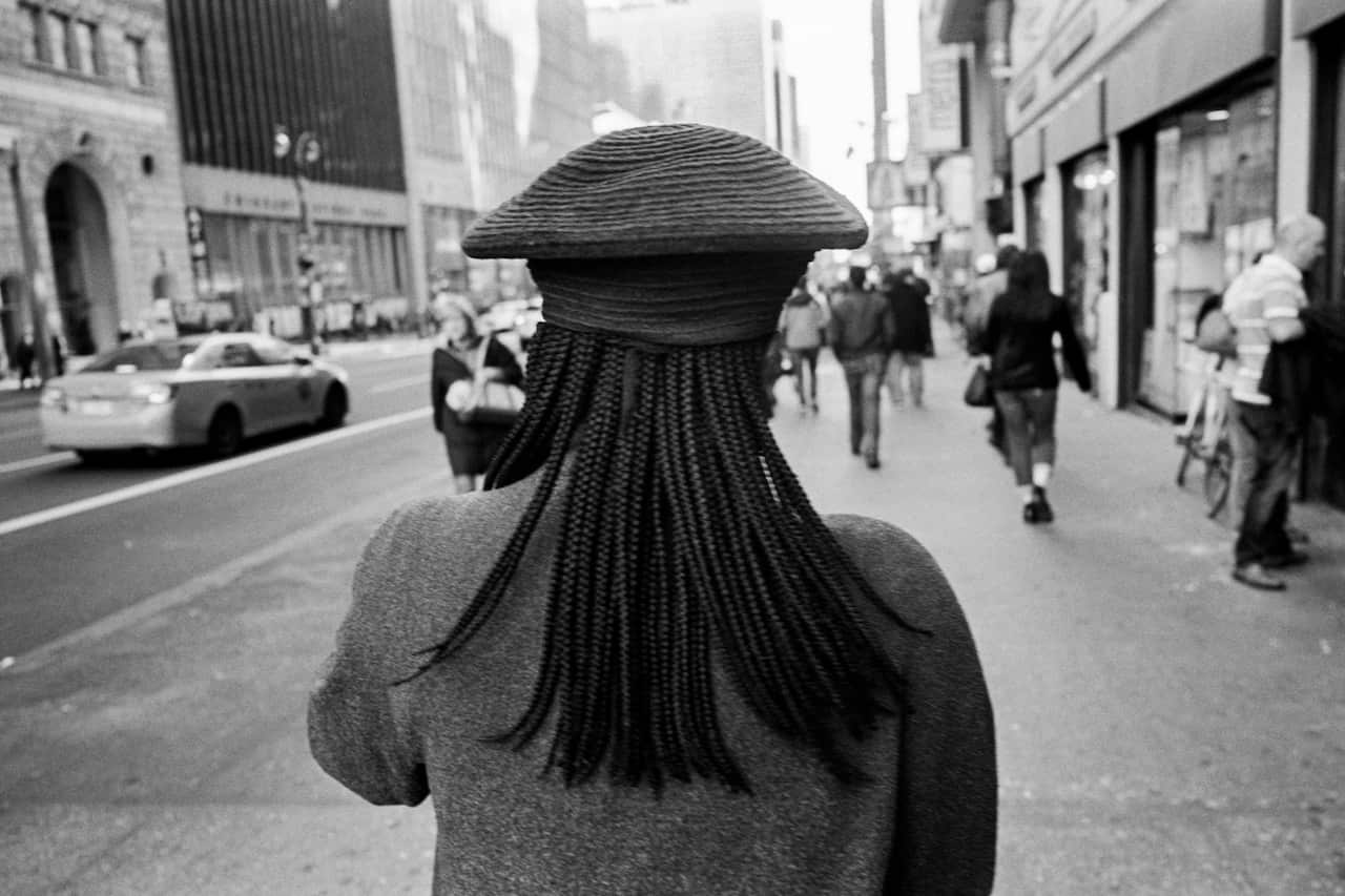 A womans hat and braids in Manhattan