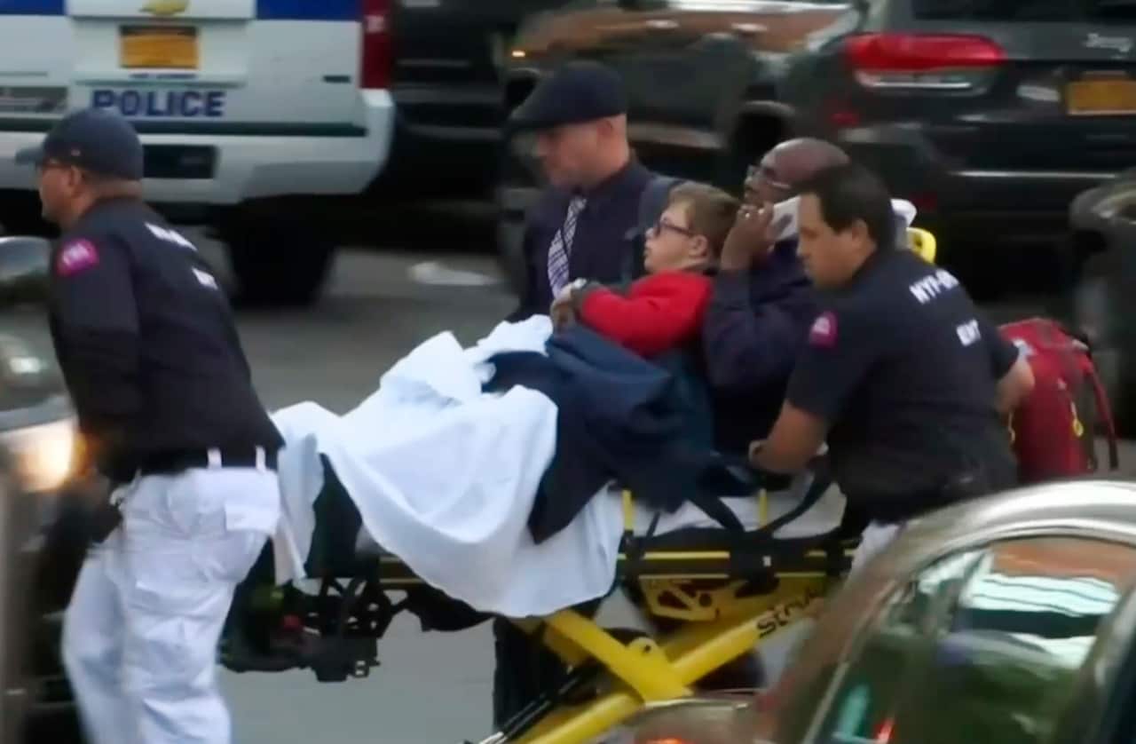 In this still image taken from video, emergency personnel respond to victims (AAP)